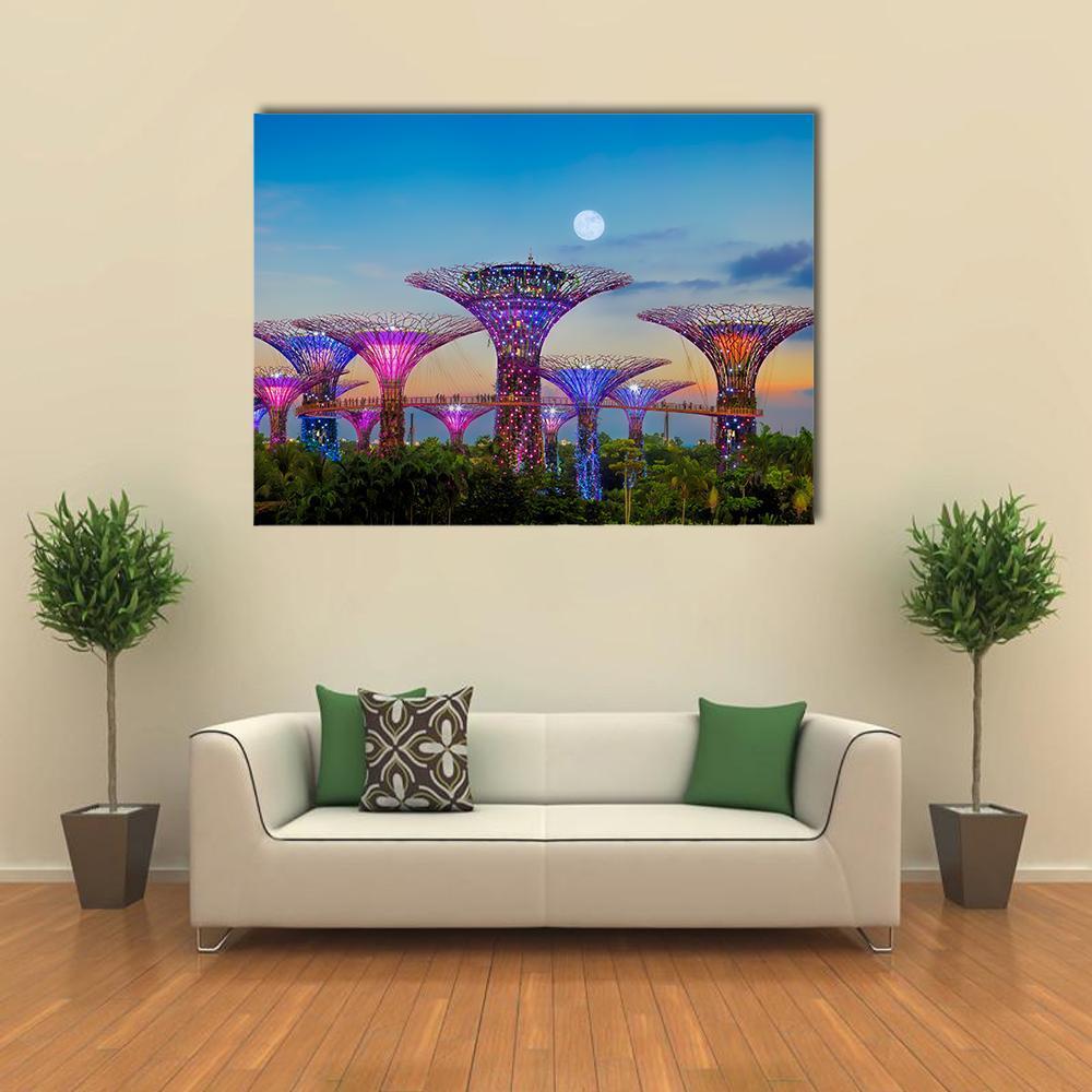 Supertrees Under a Full Moon Canvas Wall Art in green, blue and purple, single panel hung on a wall