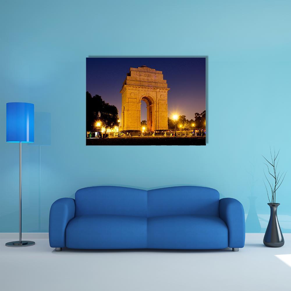 India Gate at Night Canvas Wall Art in black, yellow and blue, single panel hung on a wall