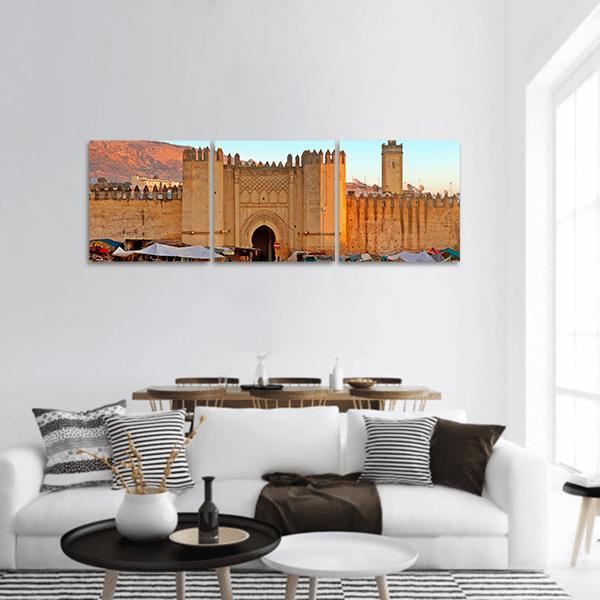 Gate of Fez Medina Panoramic Canvas Wall Art in beige, orange and blue, hung on a wall