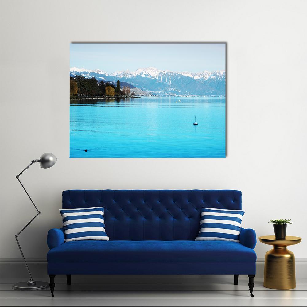 Geneva Lake Sailboat with Snow-capped Mountains Canvas Wall Art in white and blue, single panel hung on a wall