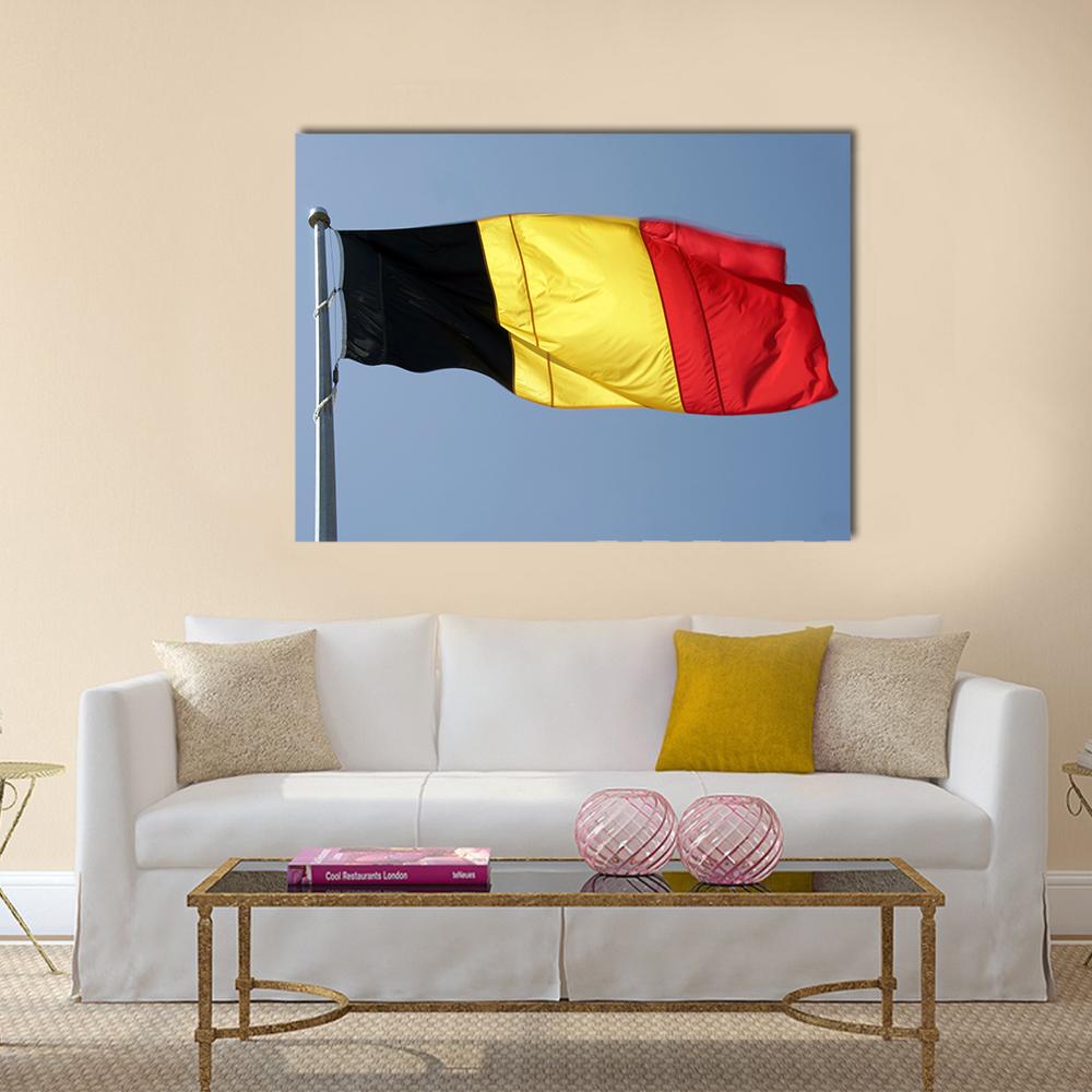German Flag Against Blue Sky Canvas Wall Art in red, yellow and blue, single panel hung on a wall