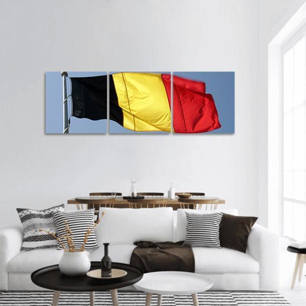 Belgian Flag Waving on Pole Panoramic Canvas Wall Art in black, red and yellow, hung on a wall