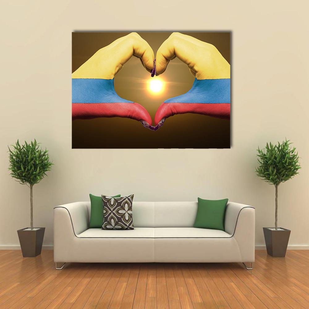 Hands Forming a Heart with Colombian Flag Canvas Wall Art in red, yellow and blue, single panel hung on a wall