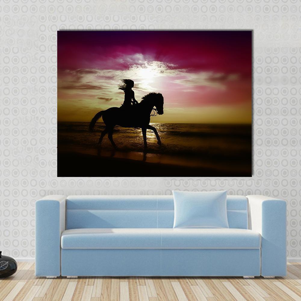 Girl Riding Horse on Beach Canvas Wall Art in black, purple and pink, single panel hung on a wall