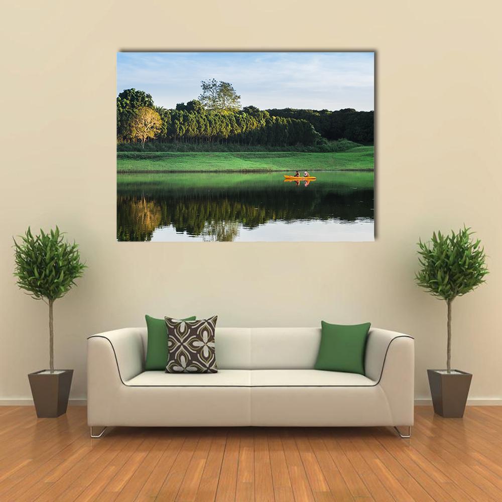 Girls Kayaking on Lake Canvas Wall Art in black, green and blue, single panel hung on a wall