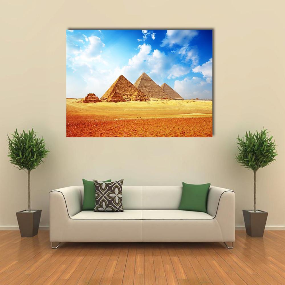 Pyramids on the Giza Plateau Canvas Wall Art in brown, yellow and blue, single panel hung on a wall