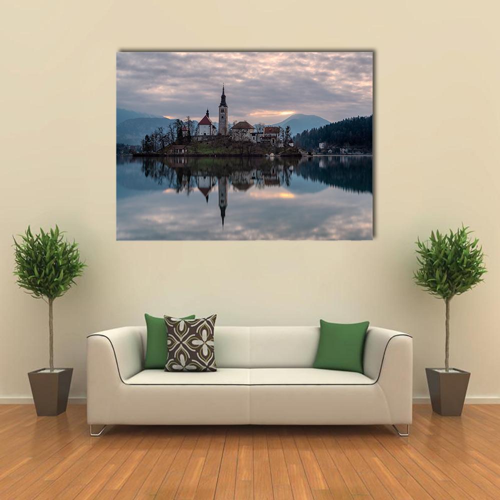 Glacial Lake Bled Reflection Canvas Wall Art in gray and blue, single panel hung on a wall