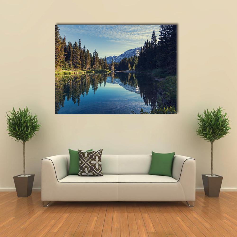 Glacier National Park Mountain Lake Reflection Canvas Wall Art in brown, green and blue, single panel hung on a wall