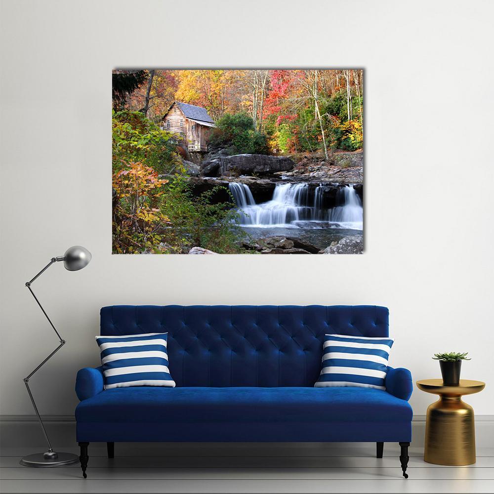Glade Creek Grist Mill with Cabin Canvas Wall Art in orange, yellow and green, single panel hung on a wall