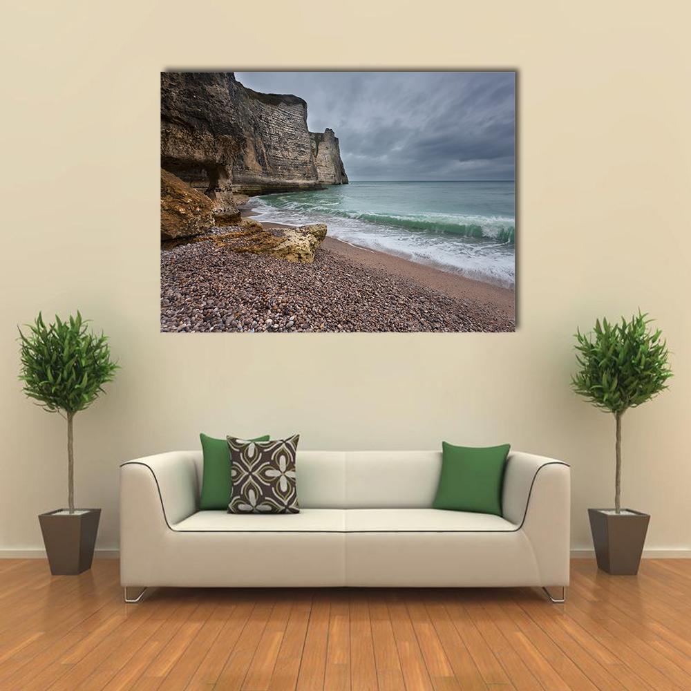 Gloomy Rocky Coast Canvas Wall Art in gray, brown and blue, single panel hung on a wall