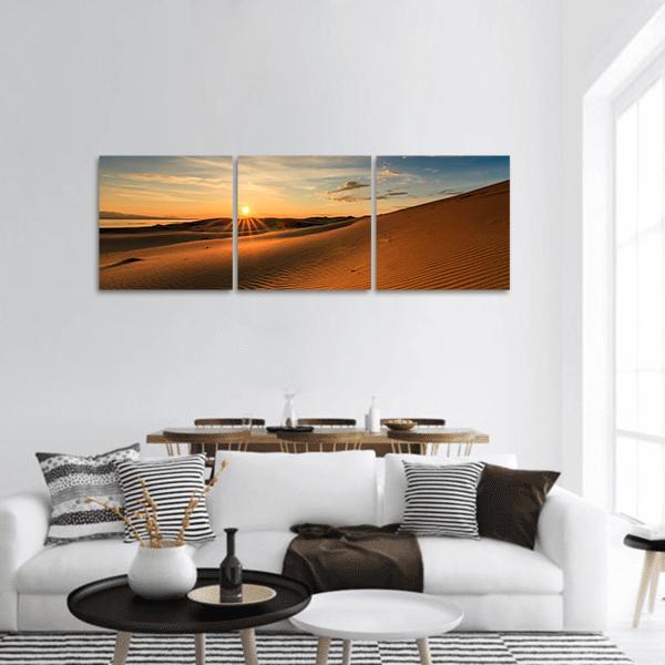 Gobi Dunes at Sunset Panoramic Canvas Wall Art in brown, orange and blue, hung on a wall