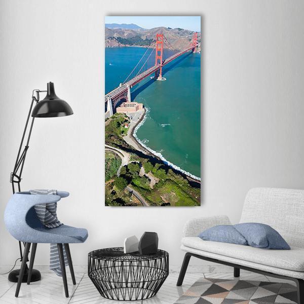 Golden Gate Bridge Aerial View Vertical Canvas Wall Art in orange, green and blue, single vertical panel hung on a wall