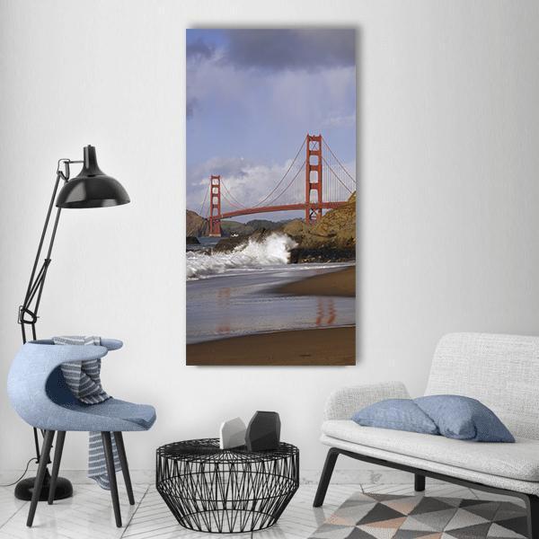 Golden Gate Bridge with Crashing Waves Vertical Canvas Wall Art in gray, brown and blue, single vertical panel hung on a wall