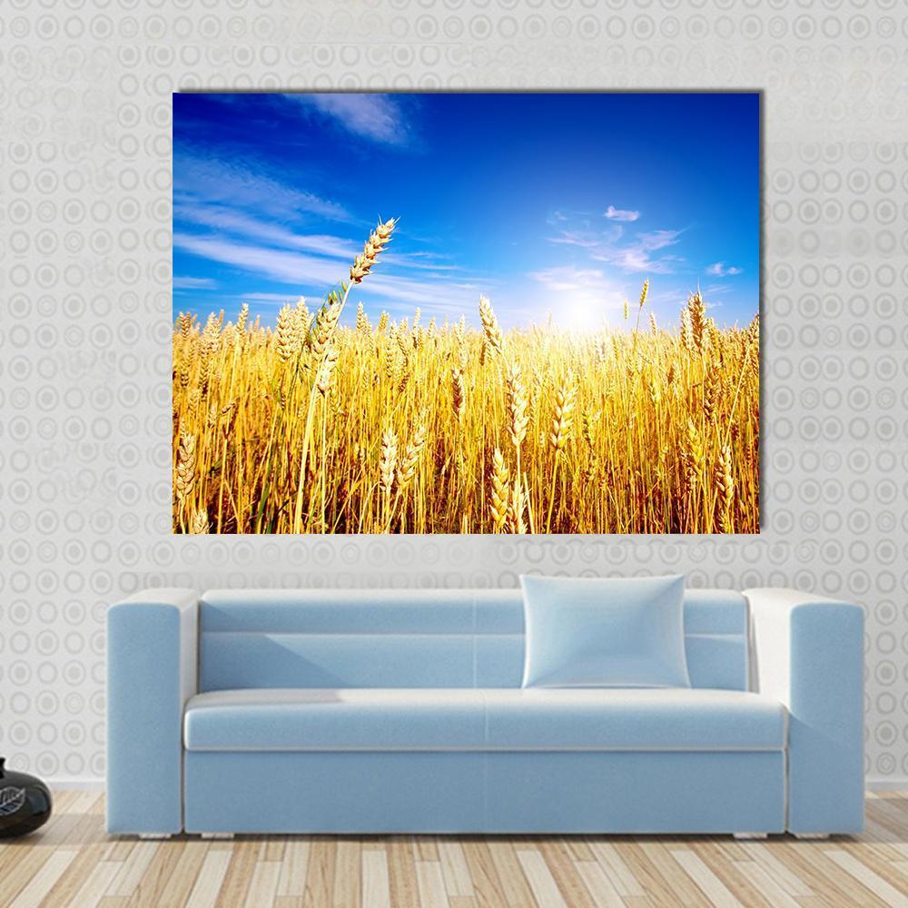 Golden Wheat Field Canvas Wall Art in gold, yellow and blue, single panel hung on a wall