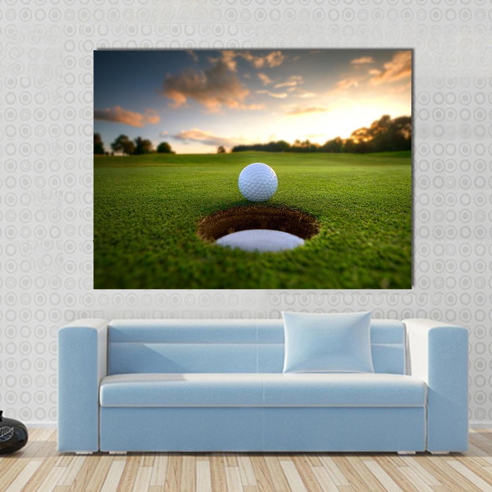 Golf Ball About to Fall Canvas Wall Art in yellow, green and blue, single panel hung on a wall