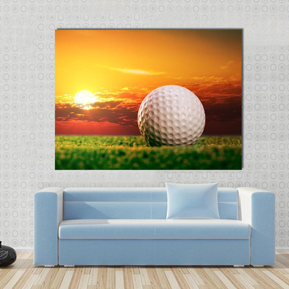 Golf Ball at Sunset Canvas Wall Art in orange, yellow and green, single panel hung on a wall