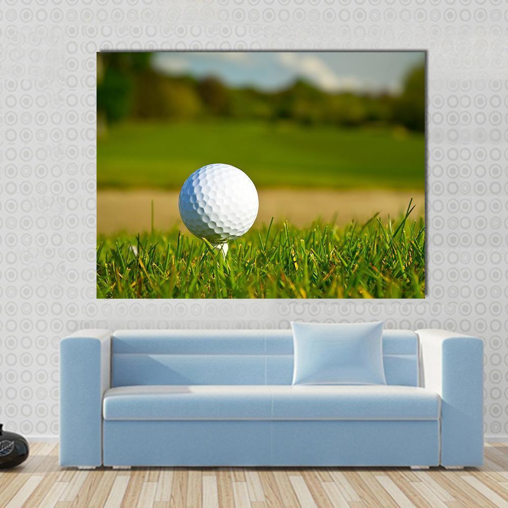 Close-up Golf Ball on Tee Canvas Wall Art in white and green, single panel hung on a wall