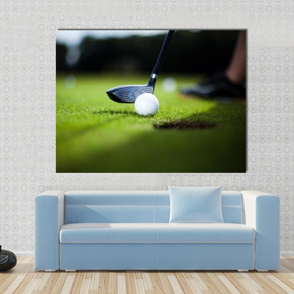 Close-up Golf Ball and Black Club Canvas Wall Art in black, white and green, single panel hung on a wall