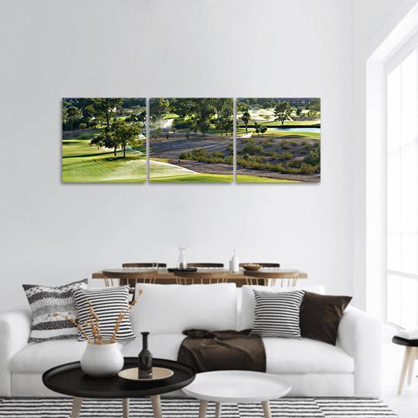 Golf Course Fairway at Golden Hour Panoramic Canvas Wall Art in brown, yellow and green, hung on a wall