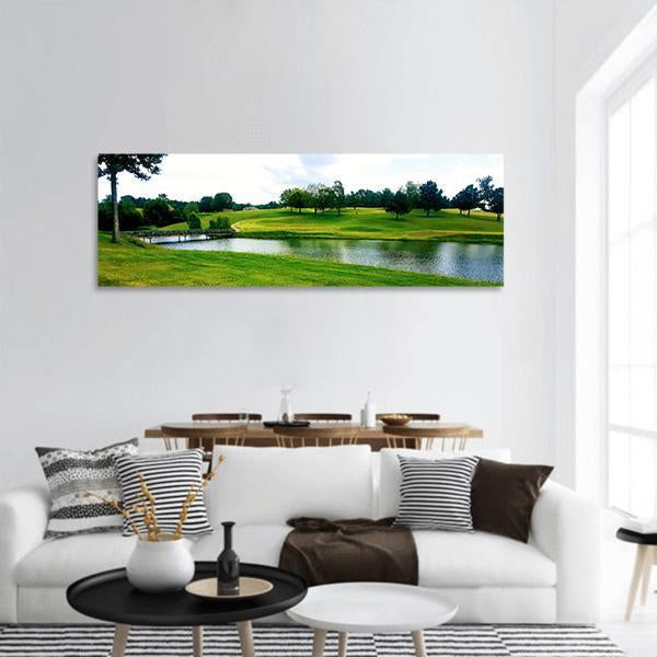 Sunny Golf Course Landscape Panoramic Canvas Wall Art in white, green and blue, hung on a wall
