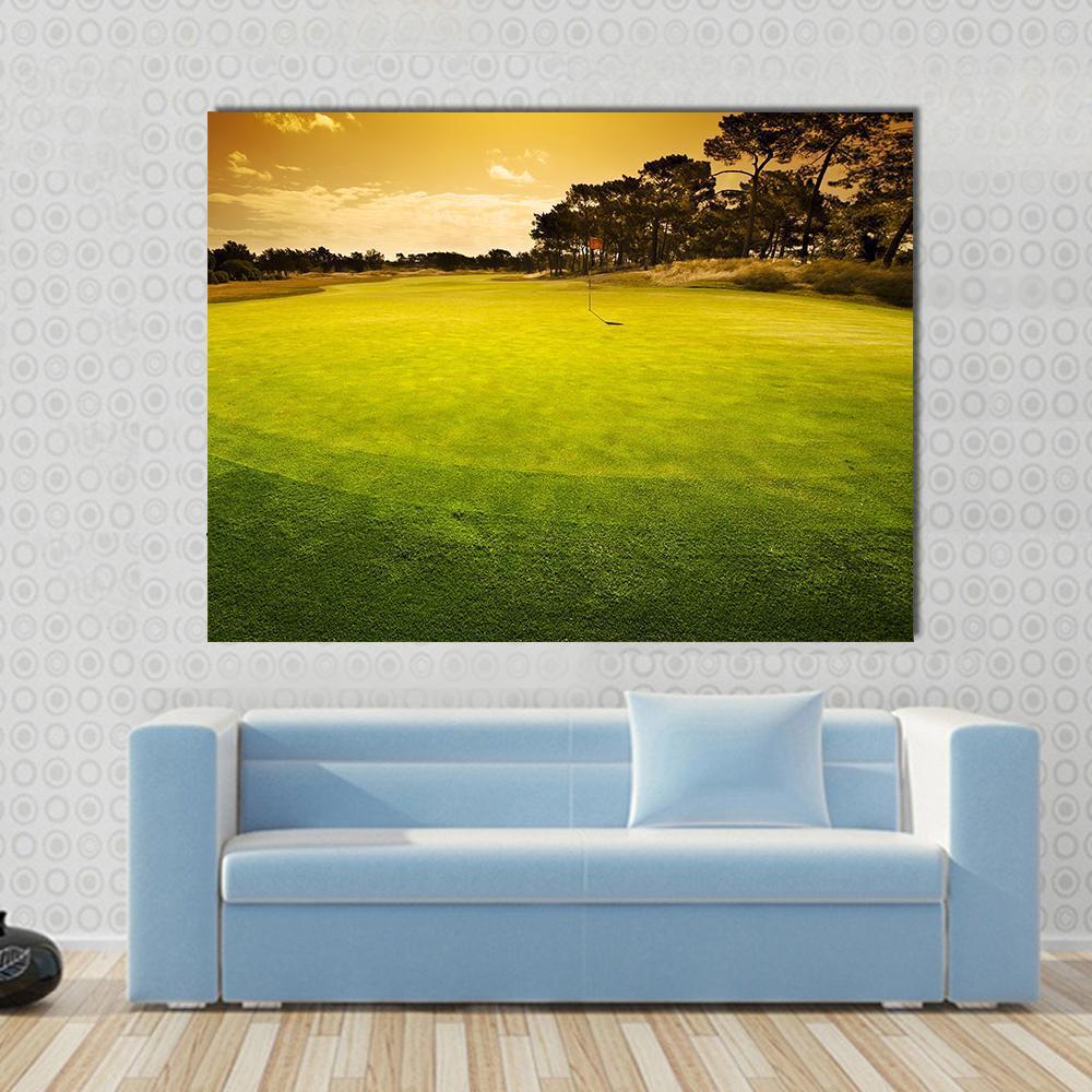 Golf Green Sunset Canvas Wall Art in orange, yellow and green, single panel hung on a wall