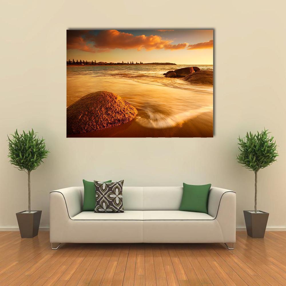 Australian Beach Sunrise Canvas Wall Art in brown, orange and yellow, single panel hung on a wall