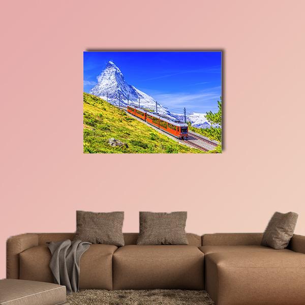 Red Cogwheel Train Toward Matterhorn Peak Canvas Wall Art in white, green and blue, single panel hung on a wall