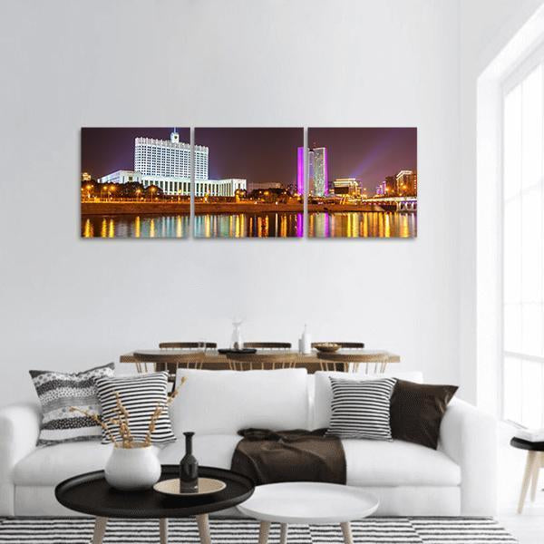 Moscow Night Skyline with White Neoclassical Building Panoramic Canvas Wall Art in black, gold and purple, hung on a wall