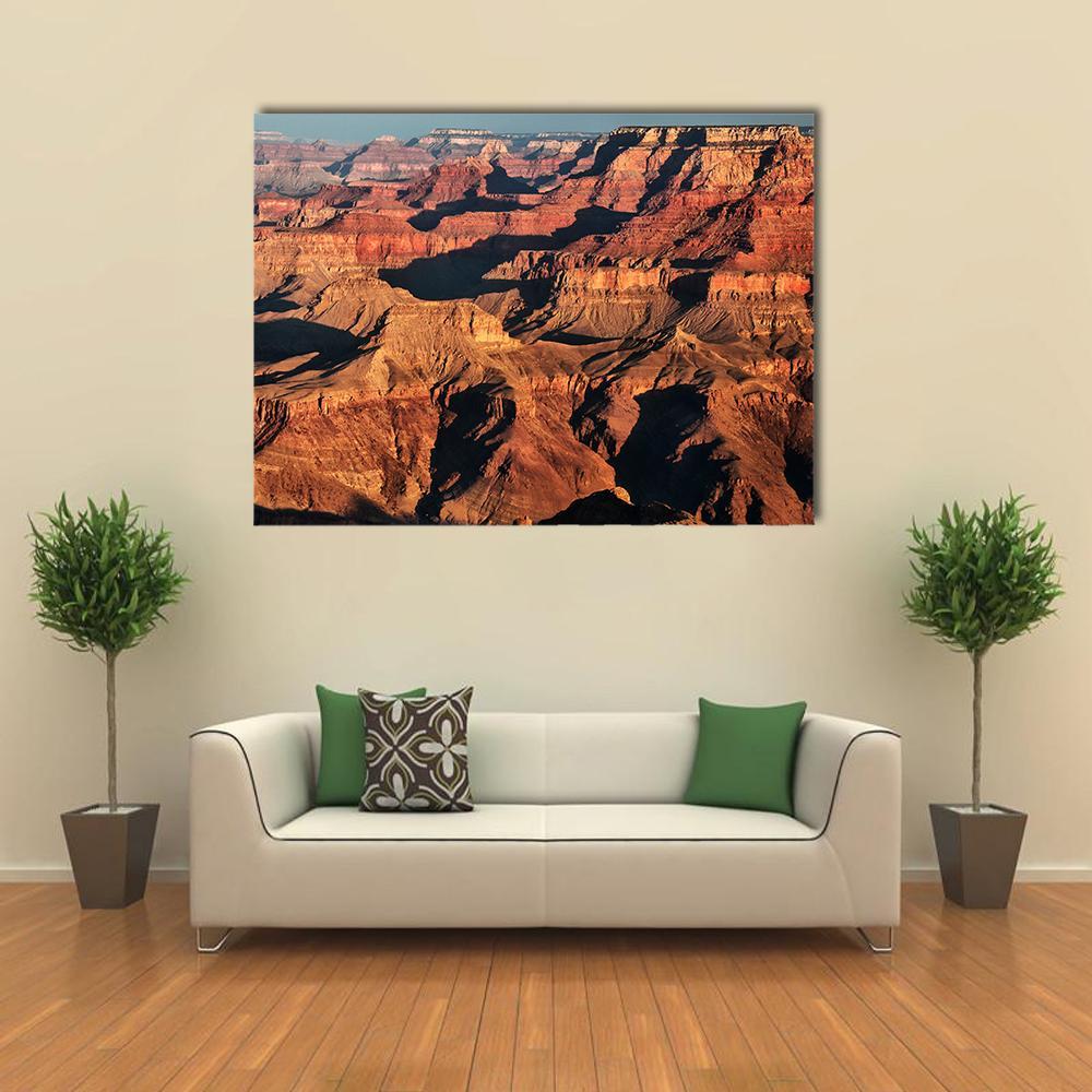Grand Canyon in Late Afternoon Light Canvas Wall Art in brown, red and orange, single panel hung on a wall