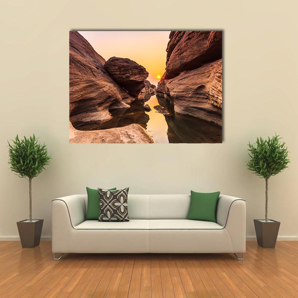 Golden Hour Canyon with Balanced Boulder Canvas Wall Art in beige, brown and orange, single panel hung on a wall