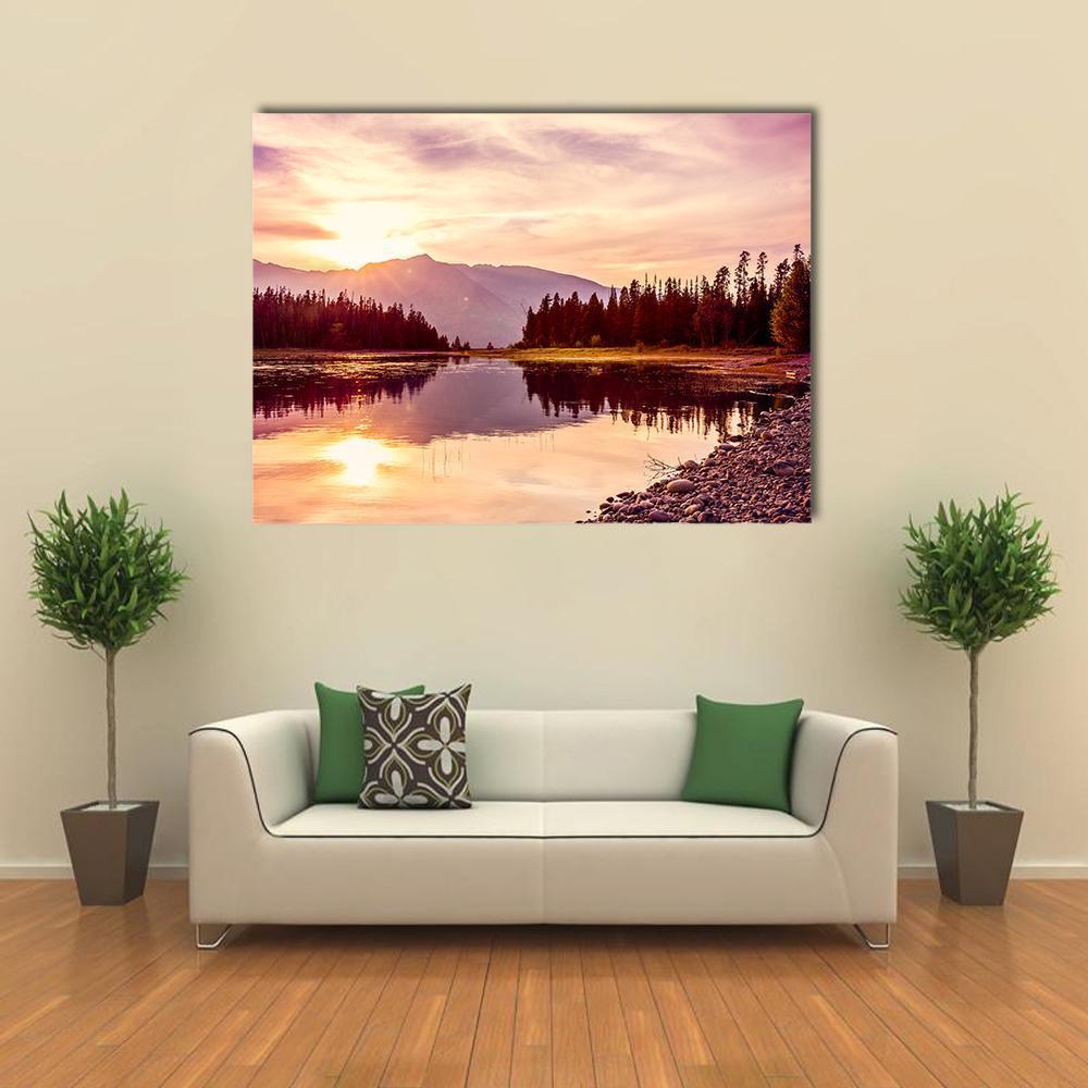 Grand Teton and Jackson Lake Sunset Canvas Wall Art in orange, purple and pink, single panel hung on a wall