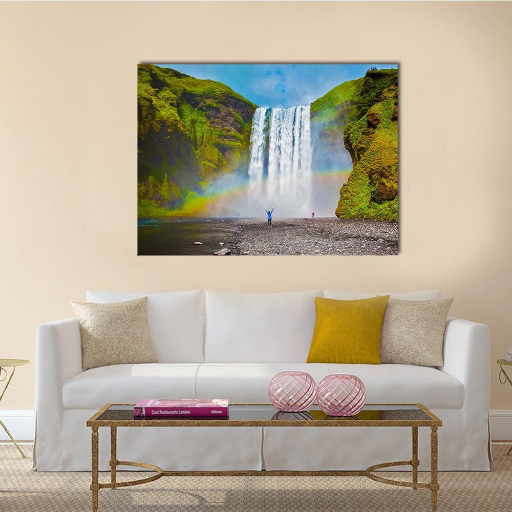 Waterfall with Rainbow and Mossy Cliffs Canvas Wall Art in white, green and blue, single panel hung on a wall