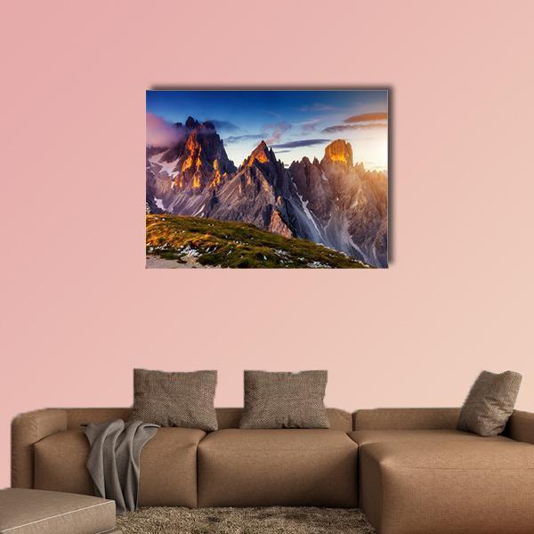 Cadini Di Misurina Peaks at Sunset Canvas Wall Art in gray, orange and blue, single panel hung on a wall