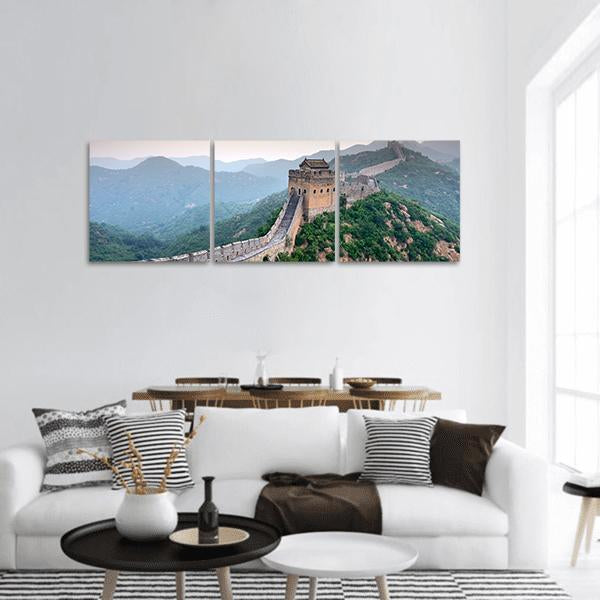 Great of China Over Mountain Ridges Panoramic Canvas Wall Art in gray, green and blue, hung on a wall