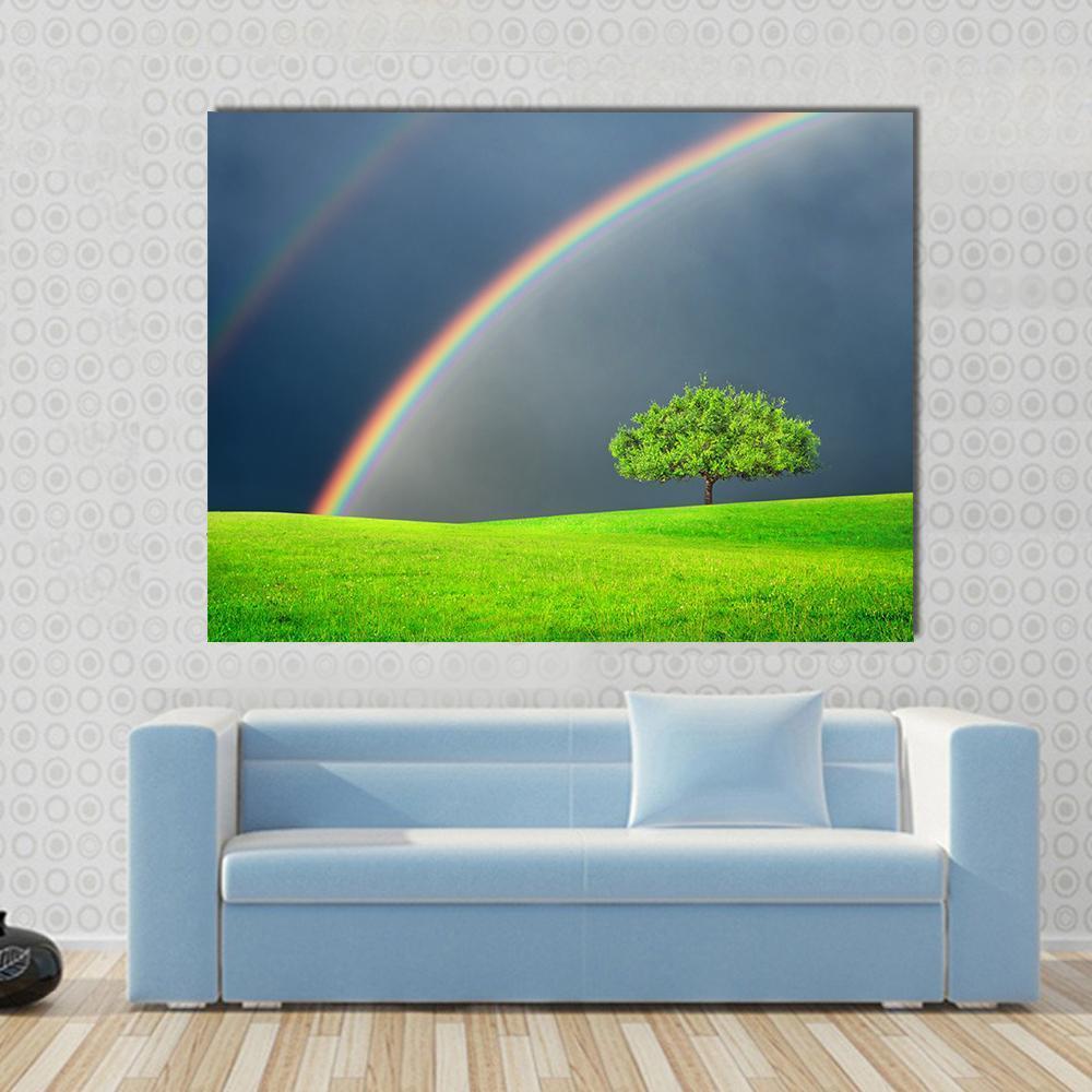 Green Field with Tree and Double Rainbow Canvas Wall Art in gray, green and blue, single panel hung on a wall