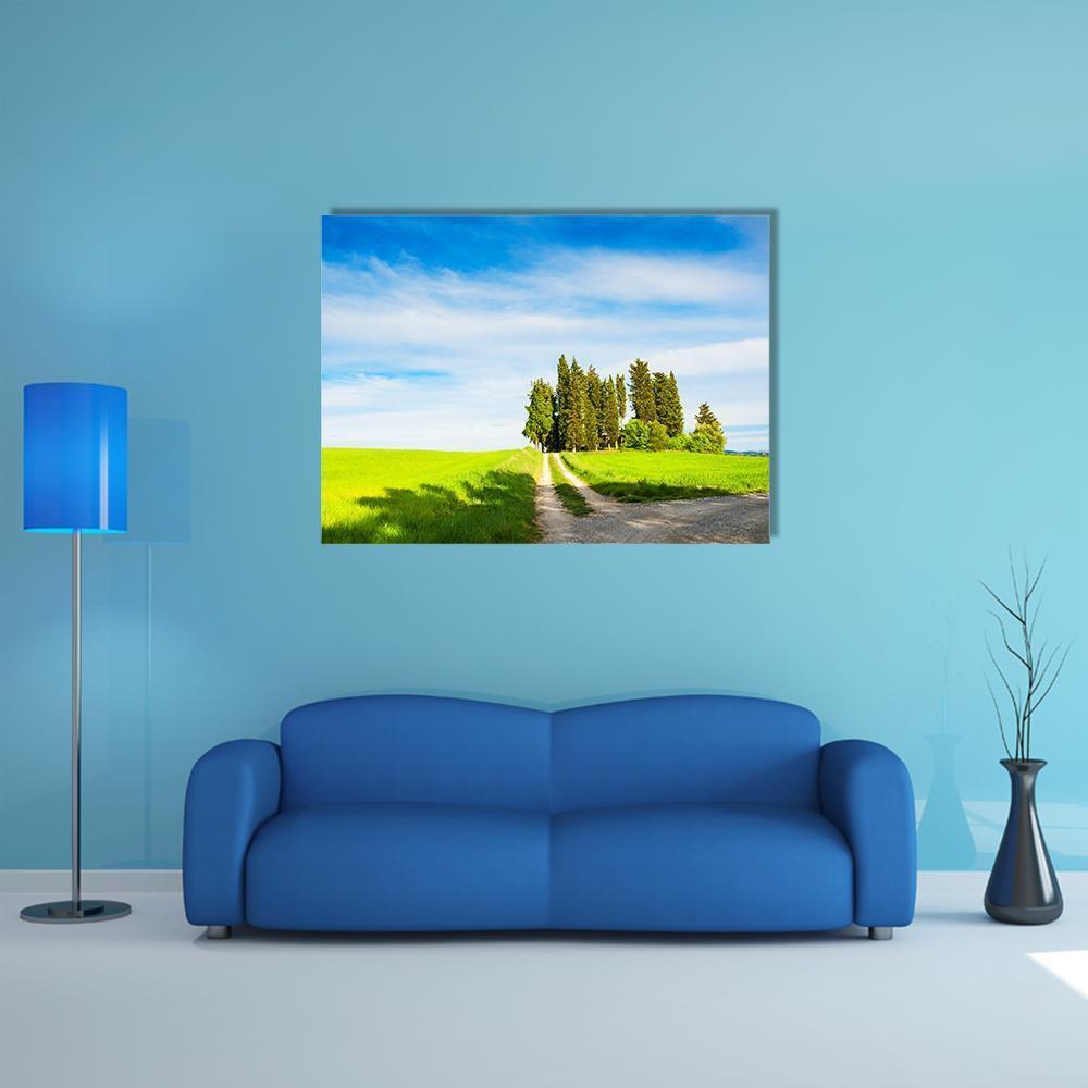 Green Fields with Cypress Trees Canvas Wall Art in white, green and blue, single panel hung on a wall