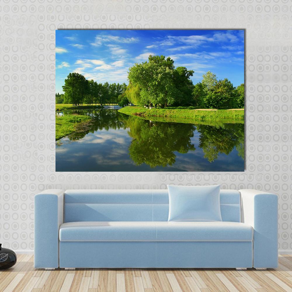 Green Fields with Lake Canvas Wall Art in green and blue, single panel hung on a wall