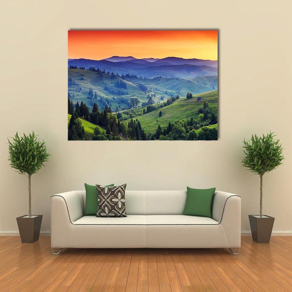 Green Hilly Valley Canvas Wall Art in orange, green and blue, single panel hung on a wall