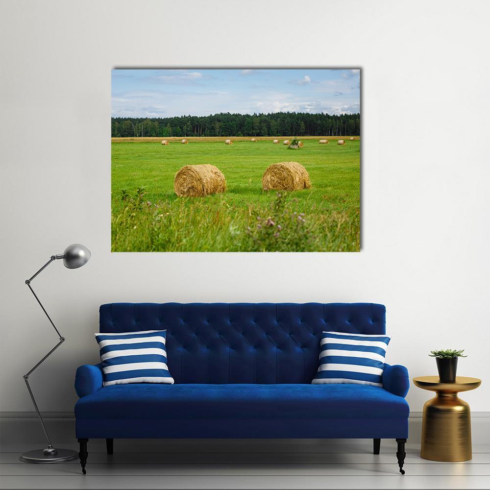 Hay Bales in a Green Meadow Canvas Wall Art in yellow, green and blue, single panel hung on a wall
