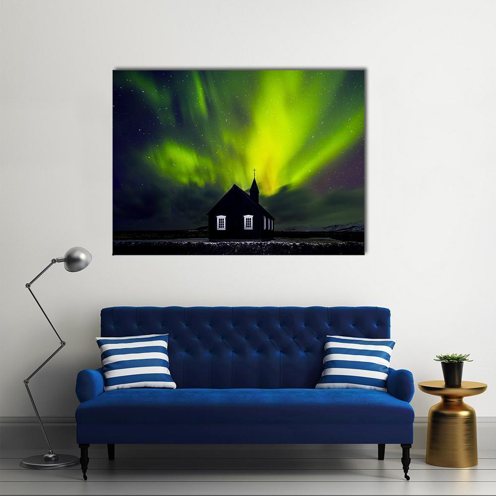 Green Northern Lights Over Church Canvas Wall Art in black and green, single panel hung on a wall