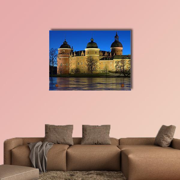 Gripsholm Castle, Sweden at Night Canvas Wall Art in brown, yellow and blue, single panel hung on a wall