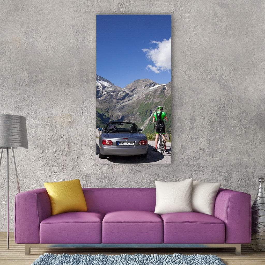 Grossglockner High Alpine Road Vertical Canvas Wall Art in gray, green and blue, single vertical panel hung on a wall