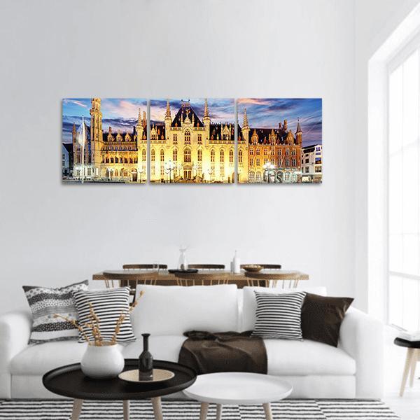 Grote Markt Bruges at Sunset Panoramic Canvas Wall Art in orange, yellow and blue, hung on a wall