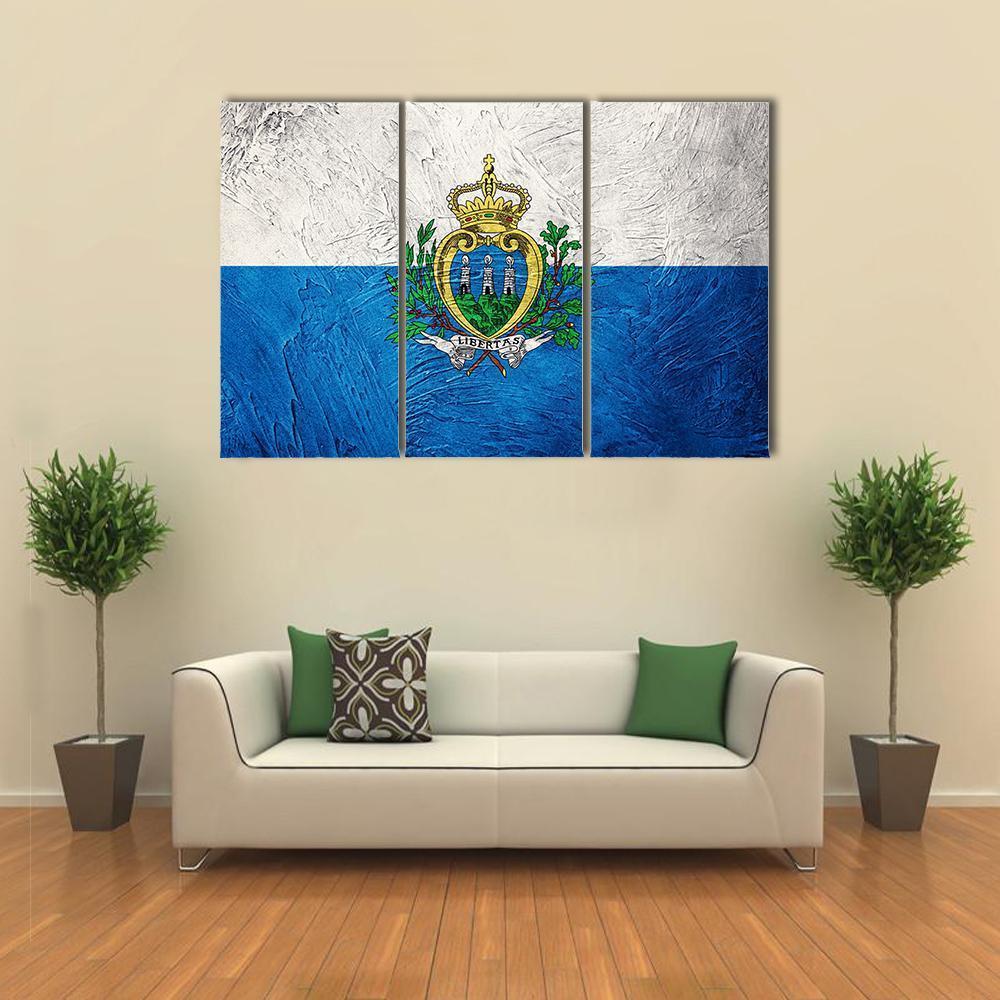 Grunge San Marino Flag Canvas Wall Art in white and blue, 3 panel horizontal set hung on a wall