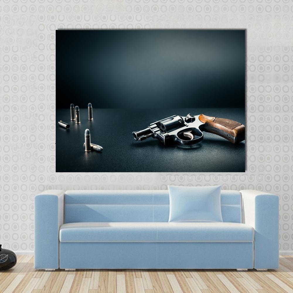 Gun with Bullet Shells Canvas Wall Art in black and gray, single panel hung on a wall