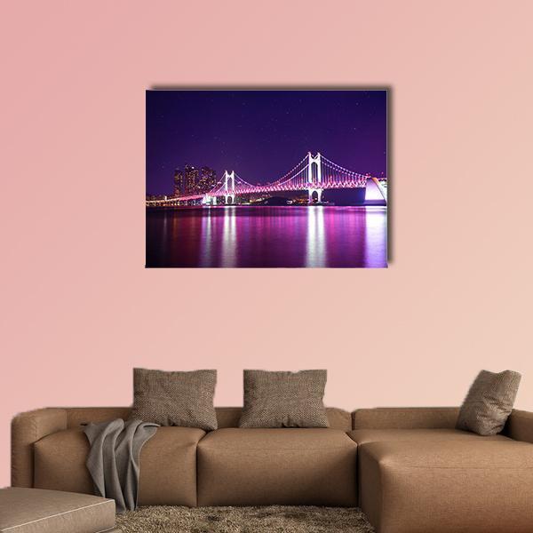 Gwangan Bridge at Night Canvas Wall Art in blue, purple and pink, single panel hung on a wall
