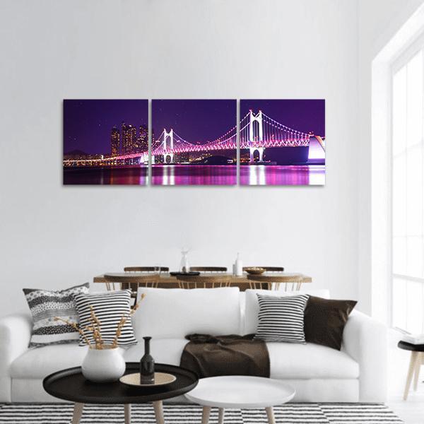 Gwangan Bridge at Night Panoramic Canvas Wall Art in black, purple and pink, hung on a wall
