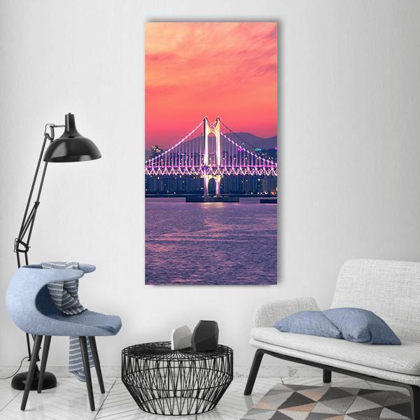 Gwangan Bridge at Night, Busan Vertical Canvas Wall Art in blue, purple and pink, single vertical panel hung on a wall