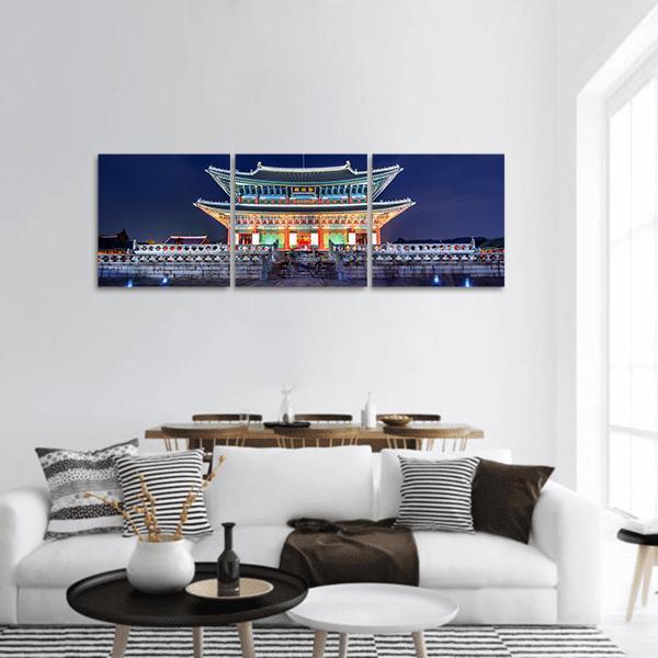 Gyeongbokgung Palace at Night Panoramic Canvas Wall Art in gold, blue and navy, hung on a wall