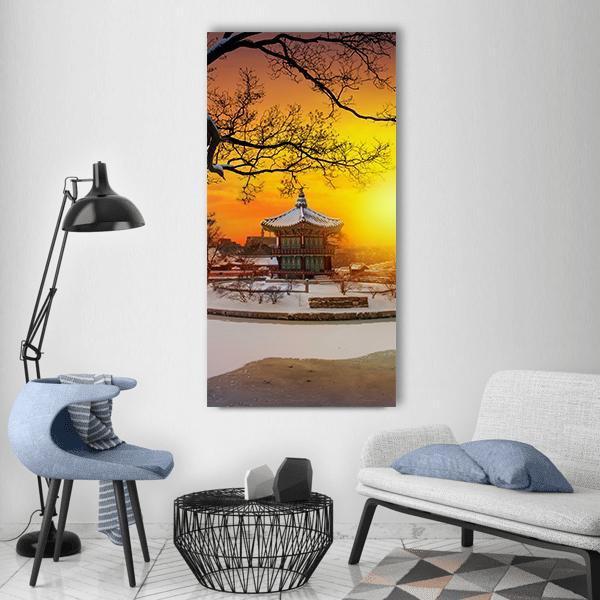 Winter at Gyeongbokgung Palace Vertical Canvas Wall Art in white, orange and yellow, single vertical panel hung on a wall